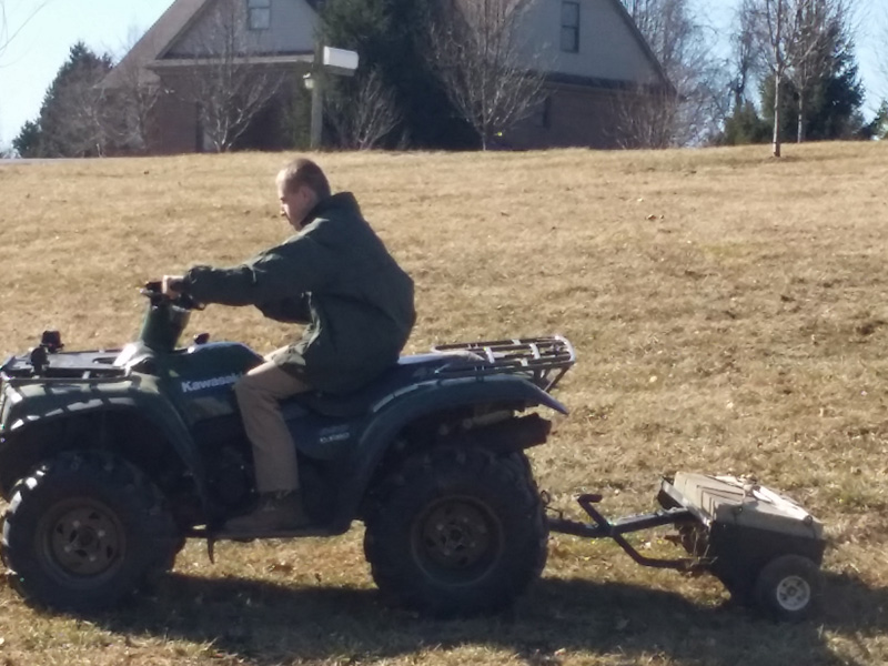A man riding on the back of an atv.