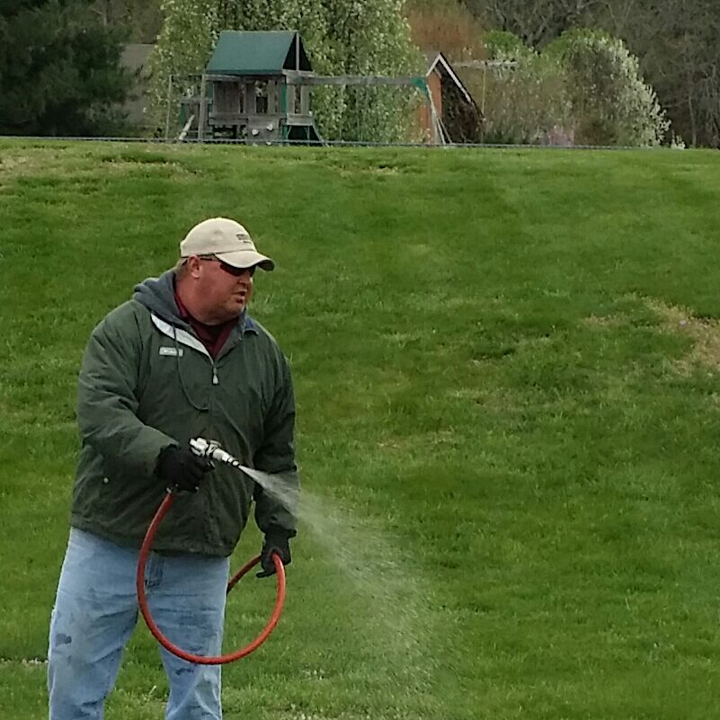 Yard Pro A man holding a hose in his hand.